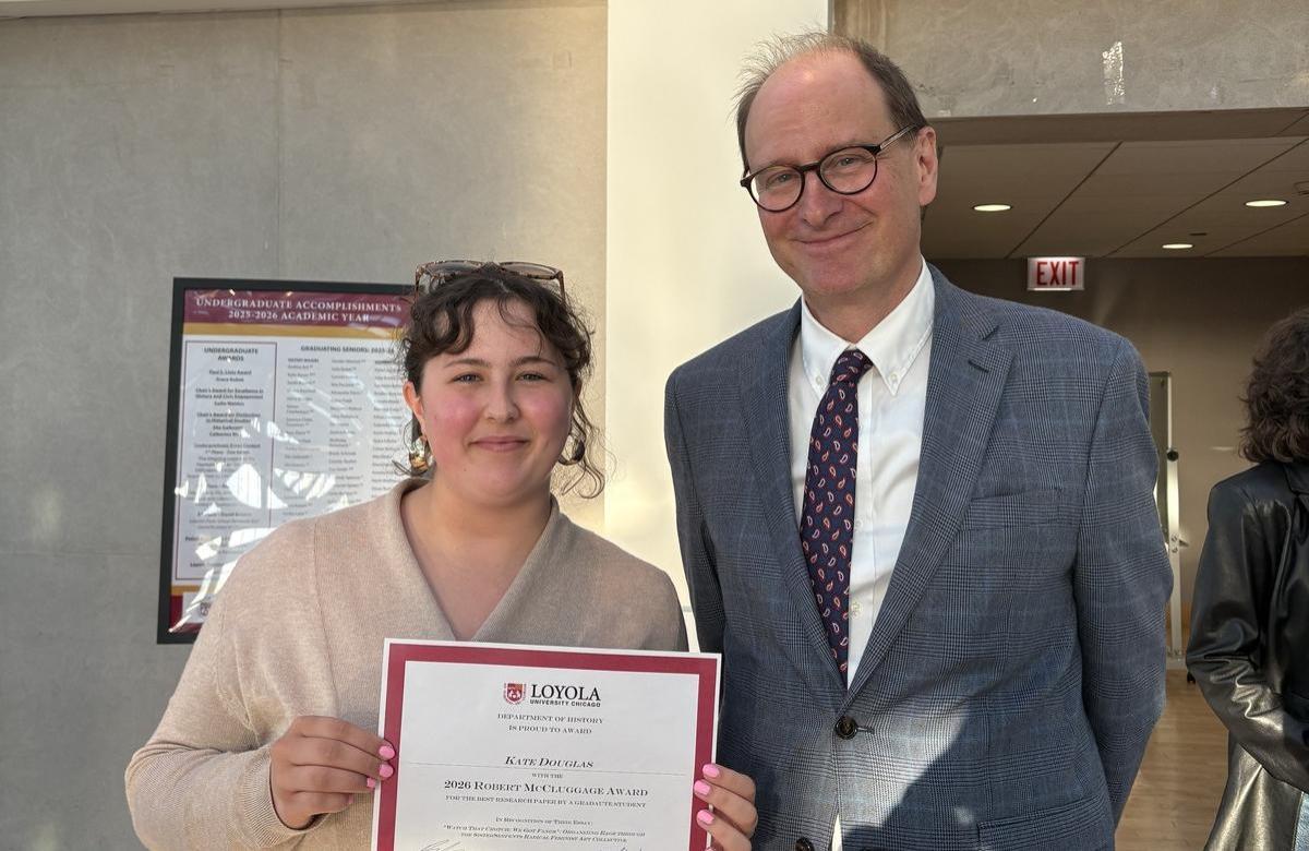Kate holding a certificate standing next to Dr. Bradford Hunt